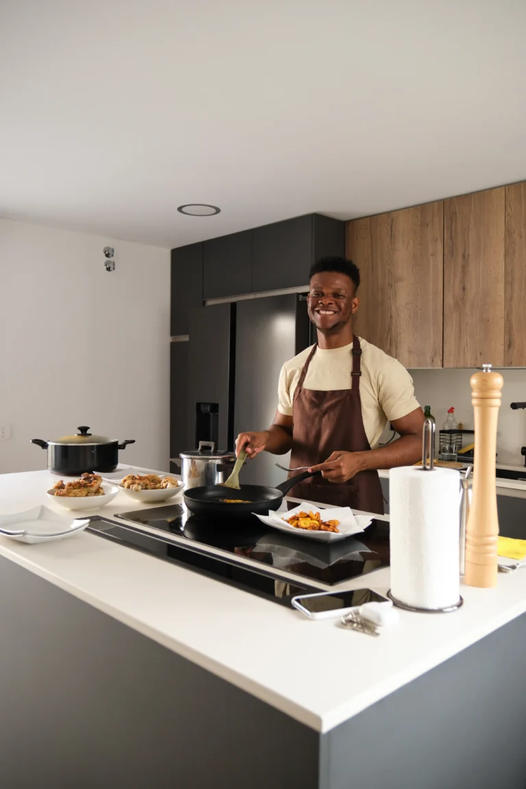 Smiling home chef Daniel Carter preparing a healthy dish in a modern kitchen