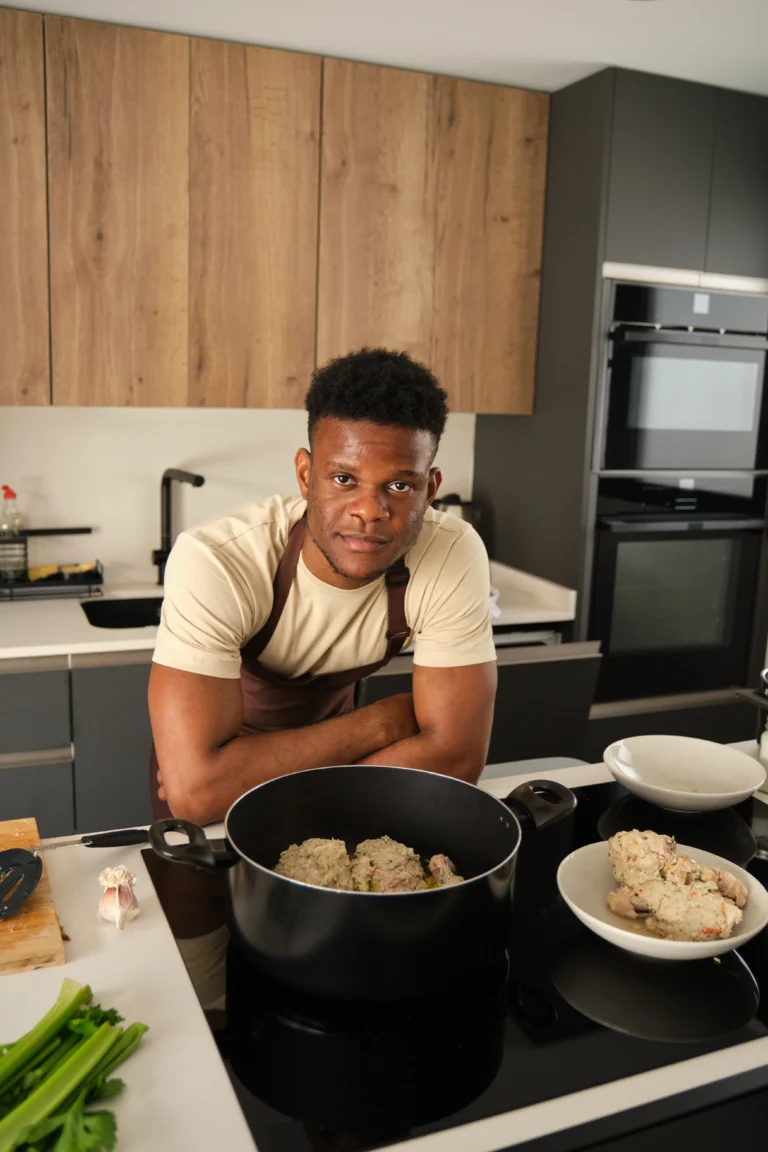 Chef Daniel Carter in a modern kitchen with a pot of healthy homemade food
