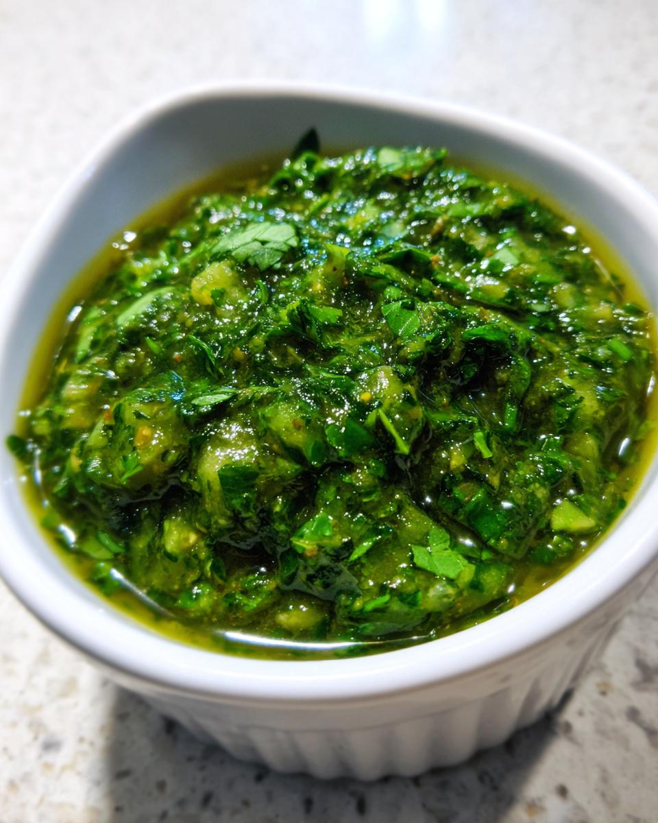 Zesty Green Salsa Recipe: 10-Minute Flavor Boost 4 Close-up of a white bowl filled with vibrant, fresh Green Salsa Recipe, showcasing chopped herbs and a glistening texture.