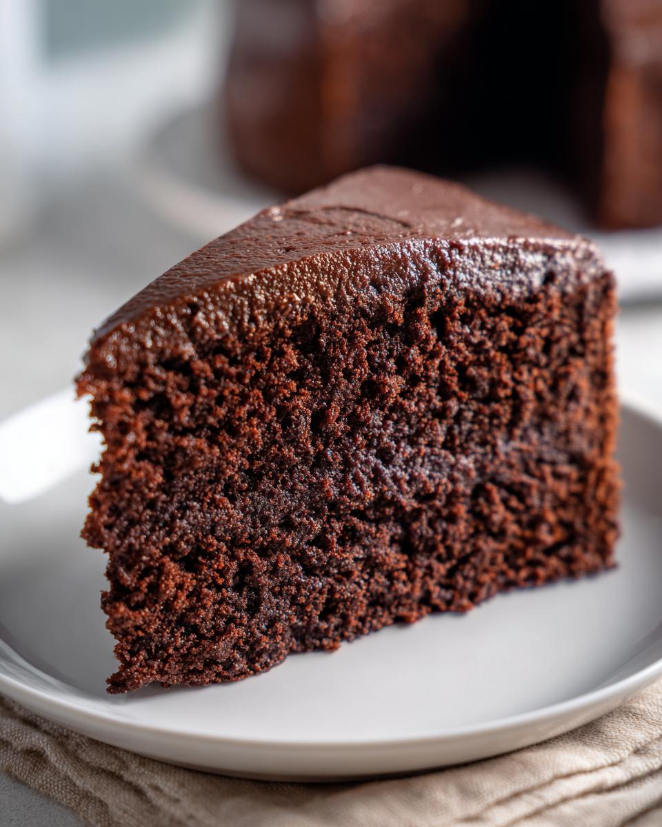 Decadent Chocolate Birthday Cake: Pure Bliss 4 A moist slice of decadent chocolate birthday cake with rich chocolate frosting.
