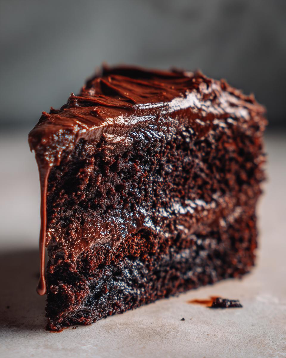 Heaven on Earth Cake: Pure Bliss Recipe 5 A decadent slice of Heaven on Earth Cake, rich chocolate cake with glossy chocolate frosting.